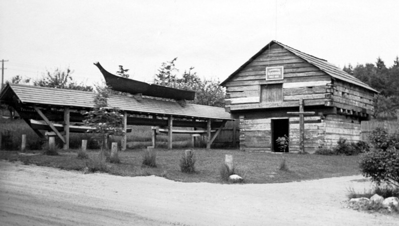 Coupeville block house with canoes and cross
